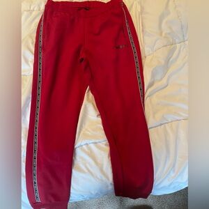 Red adidas track pants